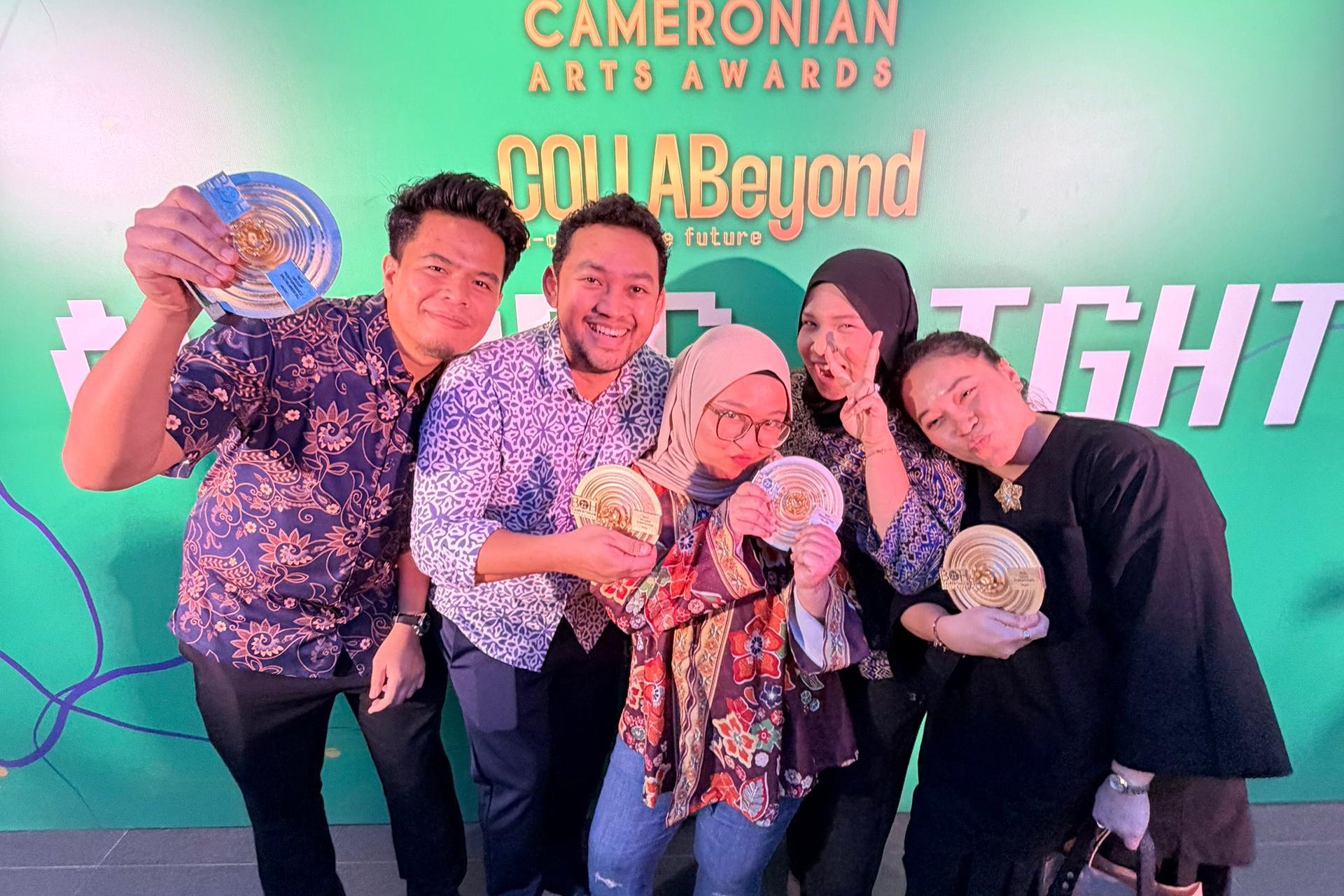 Group of people holding awards in front of a BOH Cameronian Arts Awards backdrop